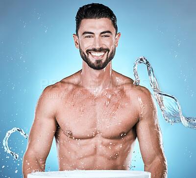 Buy stock photo Water splash, hygiene and shower with man in portrait for beauty and skincare isolated on blue background. Smile, face and cleaning body with muscle, sustainability and happy with natural cosmetics