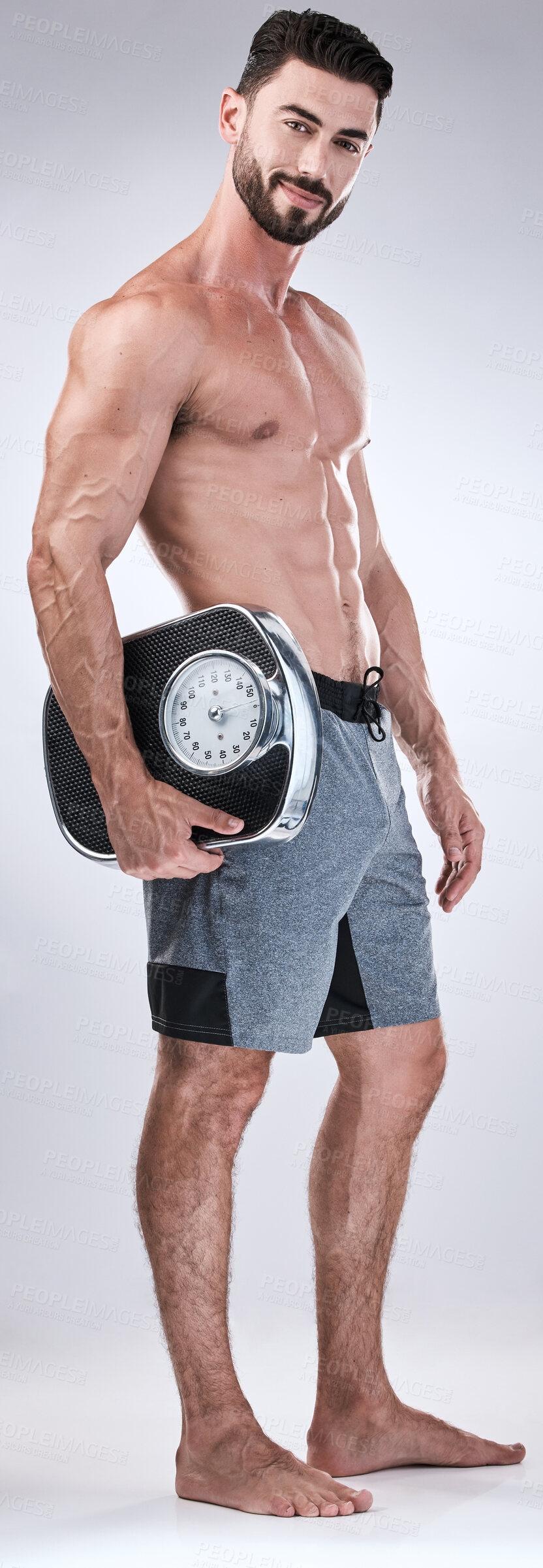Buy stock photo Fitness, exercise or man weight scale in studio after body training or gym workout for wellness goals. Healthy, progress or motivation with a male athlete in a club to monitor exercising performance