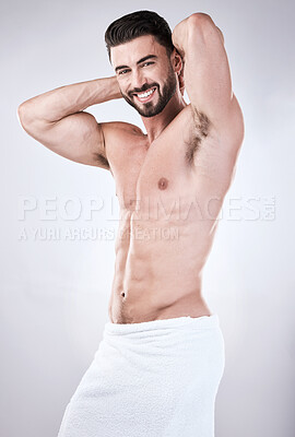 Buy stock photo Muscular man, portrait smile and towel flexing for clean hygiene, wash or skincare isolated on gray studio background. Happy attractive male model smiling for fit body, cosmetics or fresh grooming