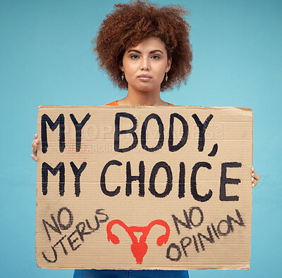 Buy stock photo Black woman, portrait and poster to protest abortion, body choice and freedom of human rights in studio. Feminist, rally and sign for safe decision, equality and support of justice on blue background