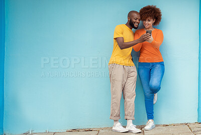 Buy stock photo Friends, wall and smartphone for social media, outdoor and connection in street, mockup and happiness. Black man, casual woman and cellphone for communication, share photos and smile in city or town