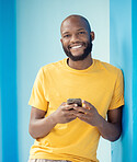 Black man, portrait or phone typing on blue background, mockup or wall mock up on social media, internet app or blogging. Smile, happy person or fashion clothes on mobile technology for trendy ideas