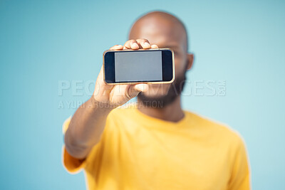 Buy stock photo Mockup screen, phone and black man advertising sale, promotion or brand on website or internet. Person with smartphone in hand on blue background studio for contact us, online contact or connection