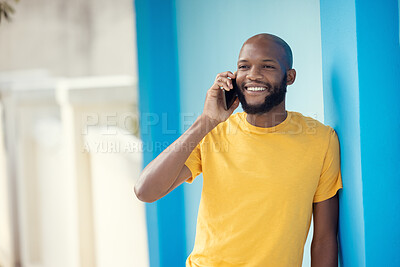 Buy stock photo Black man, fashion or phone call on blue background or city wall for talking, communication or social networking app. Smile, happy or student on mobile technology in trendy, cool or stylish clothes