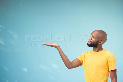 Buy stock photo Advertising, product placement and hand of black man on blue background for announcement, news and information. Marketing, thinking and male show copy space for promotion, branding and idea mockup