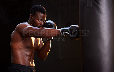 Buy stock photo Boxing, fitness and black man with training focus, energy and bodybuilder mindset in dark gym for workout. Challenge, boxer athlete or sports person with strong exercise in mma, martial arts and gear