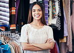 Portrait, fashion and startup with an entrepreneur black woman arms crossed in her retail clothes store. Small business, style and a trendy female shop owner standing in her clothing boutique