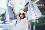 Woman, shopping bags and portrait smile in the city streets carrying gifts for discount, deal or purchase. Happy female shopper smiling in joyful happiness for luxury, fashion or sale in a urban town