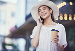 Woman, phone call and coffee on a city road for communication, travel and 5g network. Happy fashion hat person outdoor for urban journey, contact or conversation with smartphone and bokeh lights