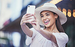 Woman, vlogger and social media with smile in the city for selfie, travel or profile picture and memories. Happy female influencer smiling for vlog, traveling or online 5G connection in an urban town