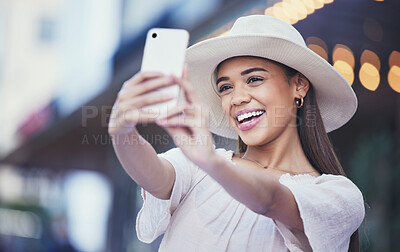 Buy stock photo Woman, vlogger and social media with smile in the city for selfie, travel or profile picture and memories. Happy female influencer smiling for vlog, traveling or online 5G connection in an urban town