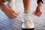 Shoes, fitness and woman getting ready for training, exercise or running in sports sneakers, fashion and motivation. Feet of athlete, runner or person tying laces for cardio or workout sportswear