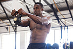 Black man with kettlebell in gym, fitness and power with arm muscle training, bodybuilder and weightlifting exercise. Biceps, strong and bodybuilding, focus and serious with commitment to workout