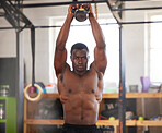 Black man, bodybuilder and kettlebell for fitness in gym, arm muscle training, portrait and weightlifting exercise. Biceps, strong and bodybuilding, focus and serious with commitment to workout