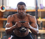 Black man with kettlebell in gym, fitness and focus with arm muscle training, bodybuilder and weightlifting exercise. Biceps, strong and bodybuilding, power and serious with commitment to workout