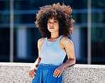 Portrait, fashion and attitude with a black woman in the city, outdoor on a bridge during a summer day. Street, style or urban and an attractive young female posing outside with an afro hairstyle