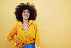 Portrait, fashion and mockup with an afro black woman in studio on a yellow background for style. Trendy, style and mock up with an attractive young female posing alone on product placement space