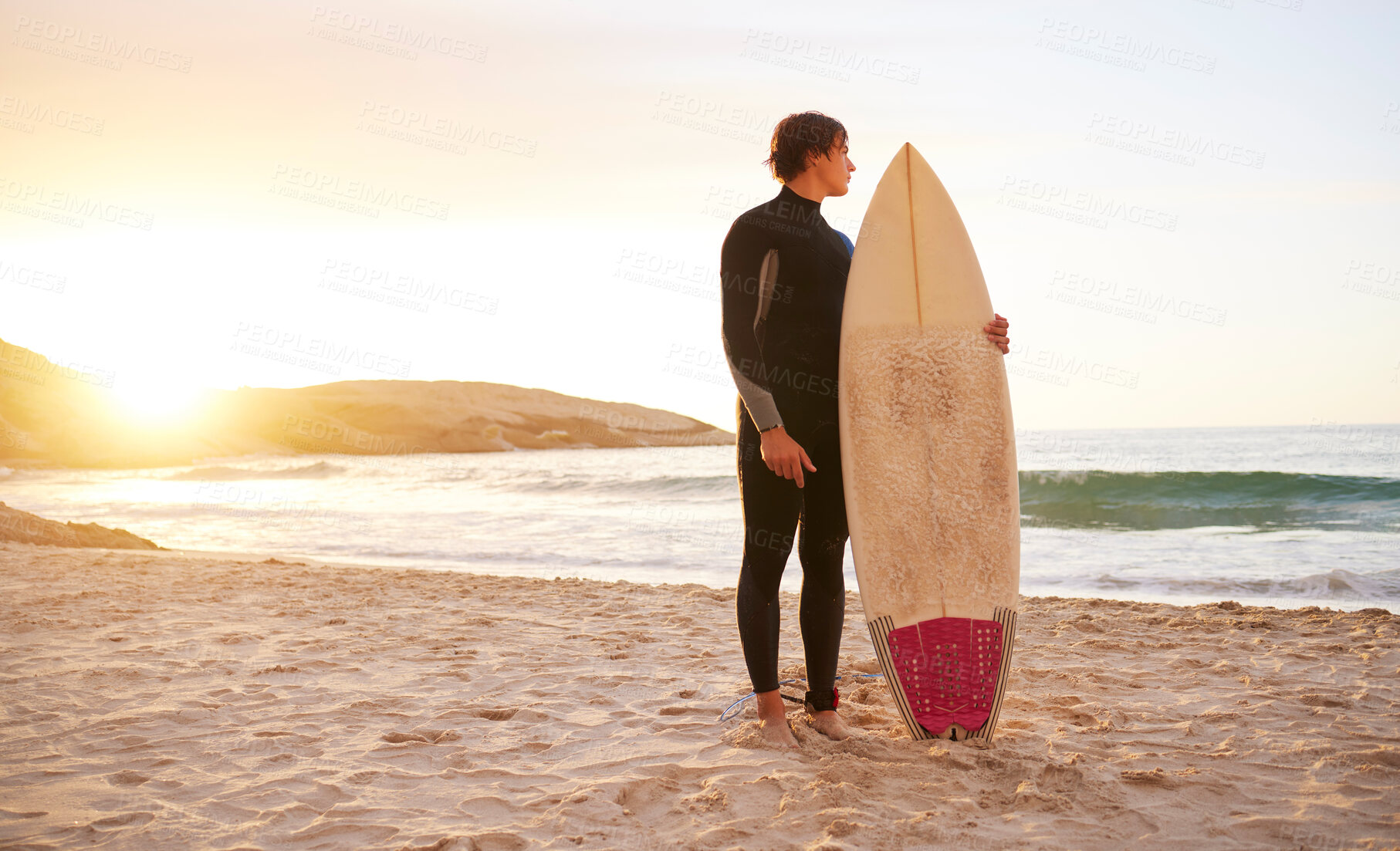 Buy stock photo Surfer, surf and man with surfboard at the beach, sea and ocean in sunset or the morning with mockup space. Young, ready and male in swimsuit on a sunny day on the sand, shore and water in summer