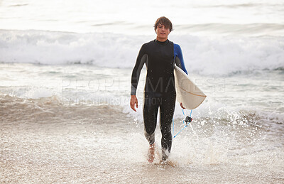 Summer, surfing and portrait of a man at the beach for water sports, relaxation and holiday in Bali. Sporty, training and surfer with a board for exercise, ocean break and activity on a vacation
