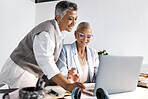 Laptop, collaboration and support with a woman manager training an employee in the office at work. Computer, teamwork and help with a female coach or supervisor at an employee desk for assistance