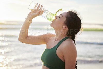 Buy stock photo Drinking water, beach and woman in fitness training, exercise or outdoor workout with nutrition, health and wellness.  Liquid bottle for diet, goals and or cardio of runner, athlete or person by sea