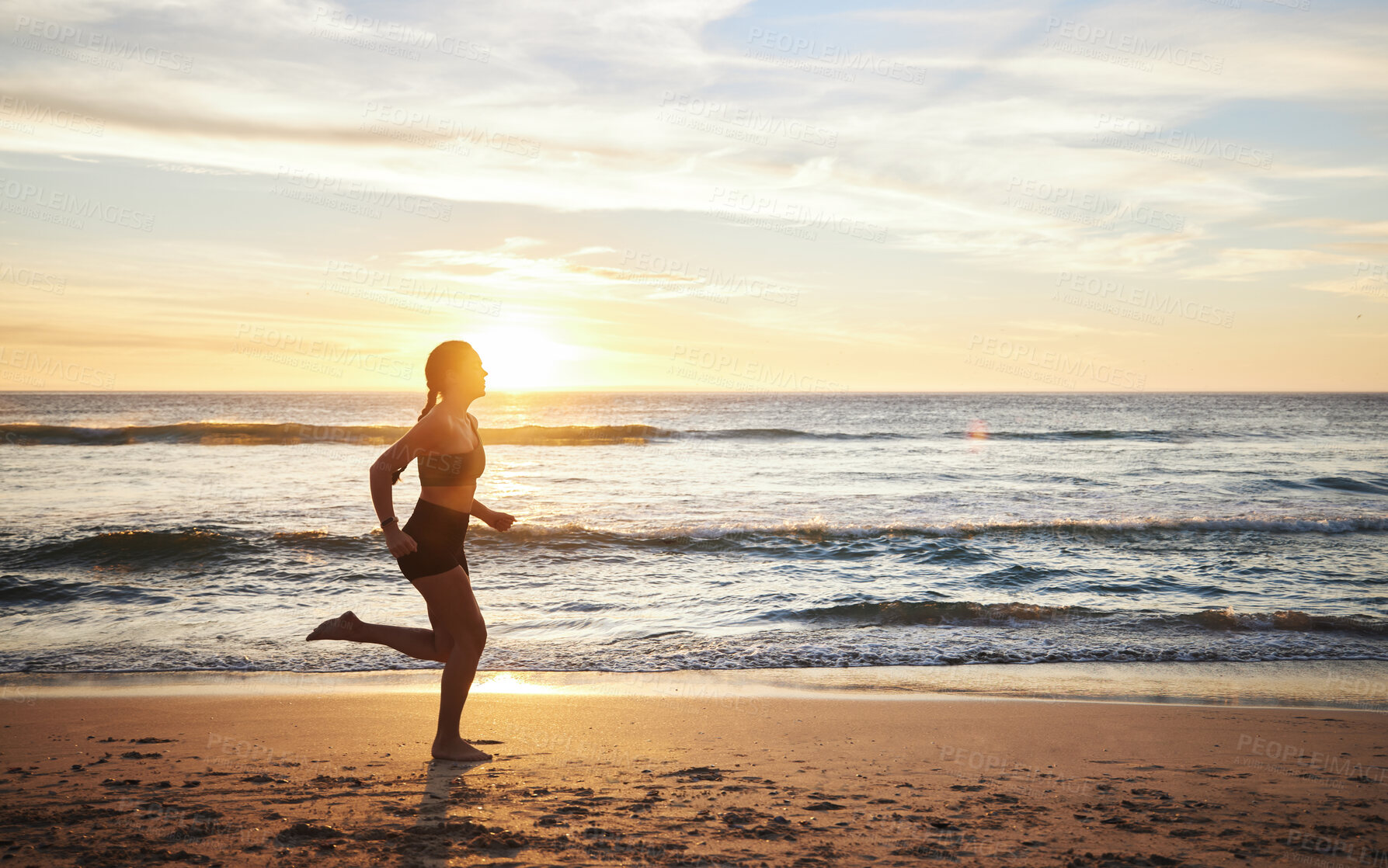 Buy stock photo Woman, fitness and running on the beach sunset for healthy cardio exercise, training or workout in the outdoors. Female runner exercising in sunrise for run, health and wellness by the ocean coast