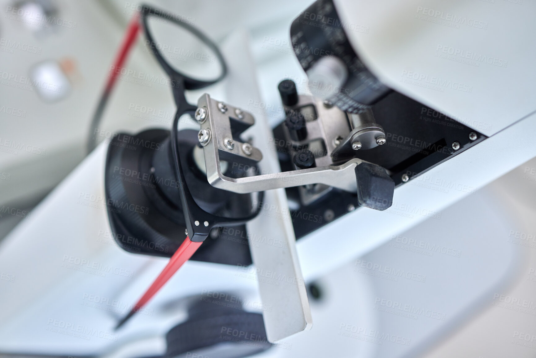 Buy stock photo Optometry, vision and a lens meter in a clinic to measure or adjust the level of eyesight improvement from above. Glasses, eyewear and machine for prescription frame spectacles in a medical office