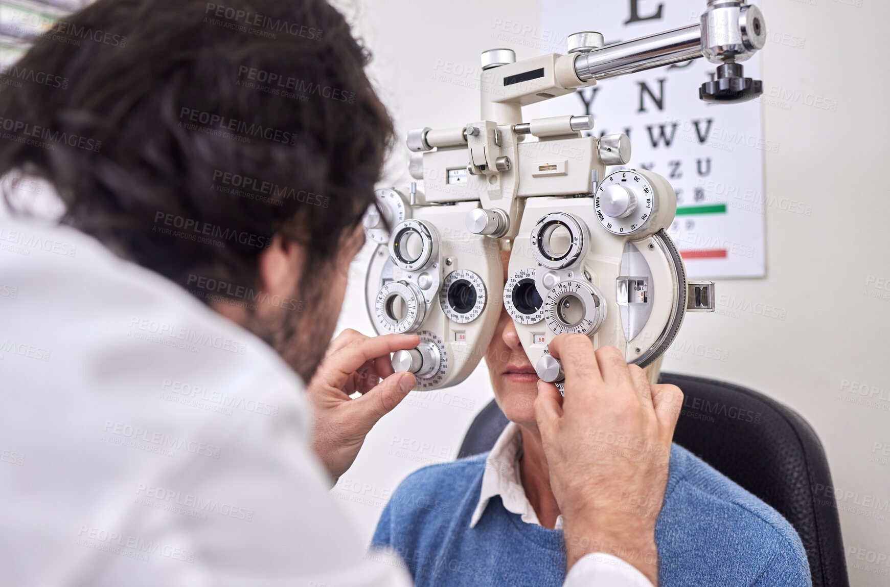 Buy stock photo Eye care, test or exam for patient and doctor AT optometry consultation for lens or frame for vision. Woman and man healthcare person with machine for eyes, eyesight and health insurance examination