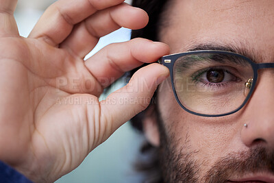 Buy stock photo Glasses, optometry and eye of man fitting prescription eyewear, spectacles and holding specs. Half, face and portrait of male person with new stylish frame for vision from optometrist or optician