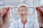 Glasses, vision and optometrist doctor hands for eye wellness and health test in a shop or hospital. Healthcare, consulting and medical employee holding a frame with tested lens for customer