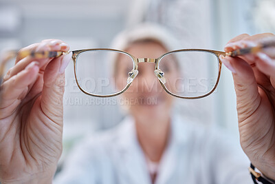Buy stock photo Glasses, vision and optometrist doctor hands for eye wellness and health test in a shop or hospital. Healthcare, consulting and medical employee holding a frame with tested lens for customer