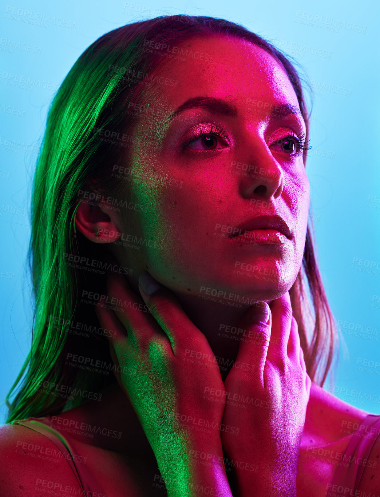 Buy stock photo Model skincare, glowing or neon lighting on isolated blue background and hands on neck, body or skin. Beauty, thinking or woman touching in creative fantasy green, pink or lights aesthetic in makeup