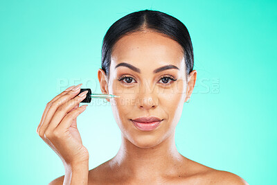 Buy stock photo Portrait, beauty and oil by woman in studio in skincare, wellness or cosmetic on blue background. Face, serum and girl with facial product for skin, anti aging or collagen, retinol or hyaluronic acid