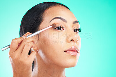 Buy stock photo Woman, hand and face in beauty makeup, skincare or self love and care isolated against a studio background. Female hands applying eyeshadow or product with brush in cosmetics for facial treatment