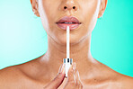 Lips, face and makeup with woman and brush for lip care, beauty and cosmetic product with dermatology isolated on studio background. Lipgloss, facial and wellness with glow, skin and mouth with shine