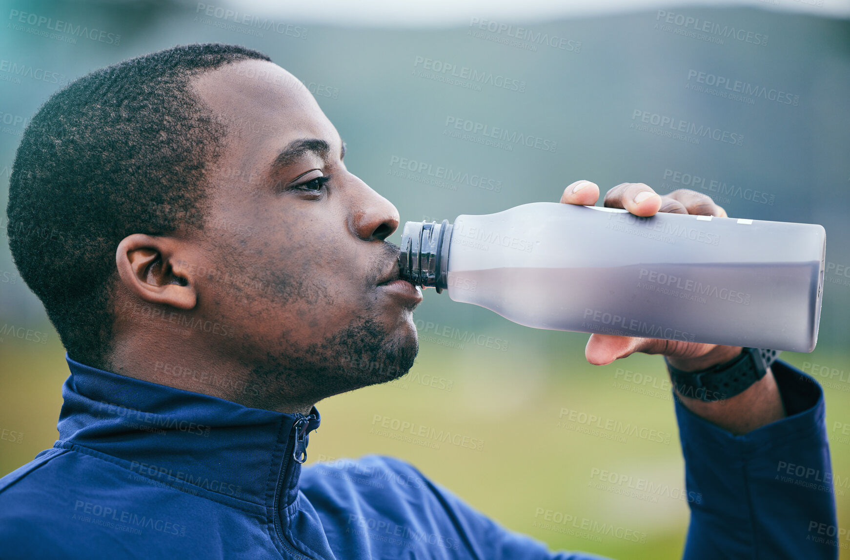 Buy stock photo Fitness, health and side profile of black man drinking water to hydrate after running, exercise and workout. Healthy, sports and African athlete with a drink after training and cardio in Germany