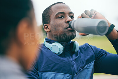 Buy stock photo Break, fitness and black man drinking water after a race, training and sports at a stadium in Morocco. Health, relax and African athlete with a drink to hydrate after a workout, running and exercise