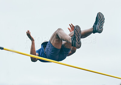 Buy stock photo Fitness, athletics high jump by man at a stadium for training, energy and cardio against sky background. Jumping, athlete and male outdoors for performance, endurance and competition on mock up