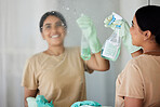 Happy, woman and cleaning mirror with smile, spray bottle and soap, housekeeping in home or hotel. Housework, smudge and housekeeper or cleaner service washing dirt off glass reflection in apartment.