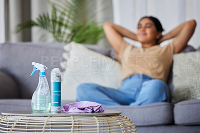 Buy stock photo Cleaning product, woman and sofa to relax, rest or sleep for domestic work in living room with relief. Happy cleaner, lounge couch with spray, cloth and bottle on table for service, job and hygiene
