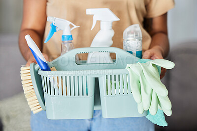 Buy stock photo Cleaning, supplies and basket in the hands of a woman housekeeper for domestic hygiene or sanitizing. Covid, service and housekeeping with a female cleaner holding a container of disinfectant