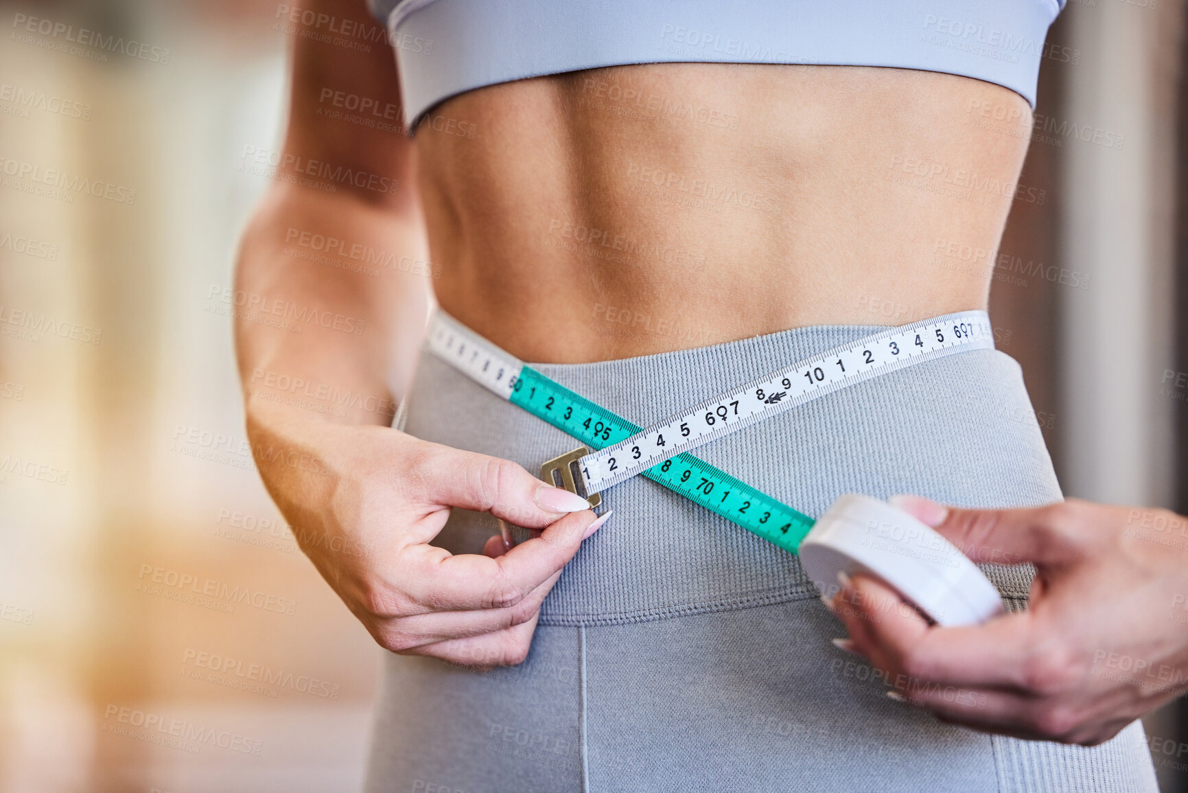 Buy stock photo Tape measure, stomach and woman at gym for weight loss, diet or exercise on blurred background. Fitness, measuring and girl on flat belly from training, workout or healthy lifestyle results on mockup