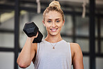 Woman, dumbbell and gym portrait of a athlete with a smile ready for training, exercise and workout. Sports, happiness and young person bodybuilder in a health, wellness and sport center for body