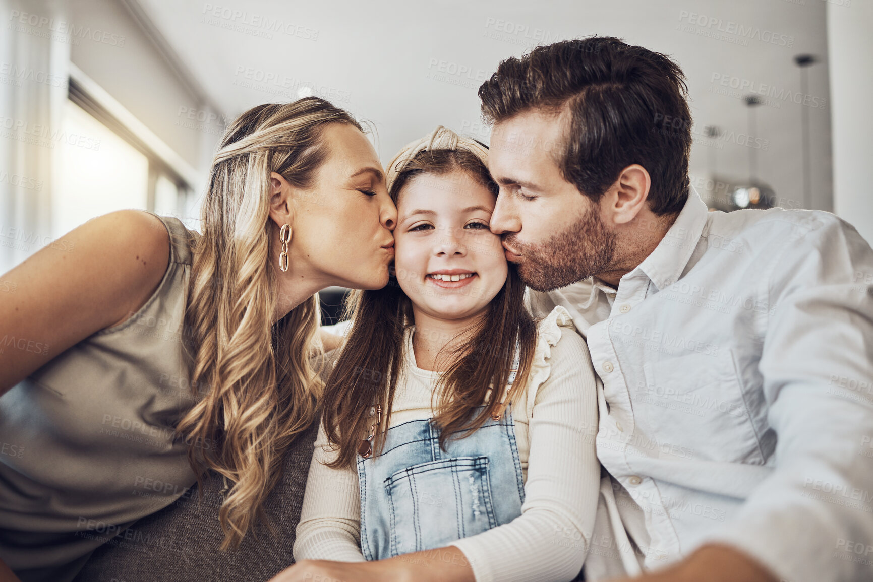Buy stock photo Portrait, mother or father kiss a girl or child as a happy family in living room bonding in Australia with love or care. Relax, trust or parents smile with kid enjoying quality time on a fun holiday