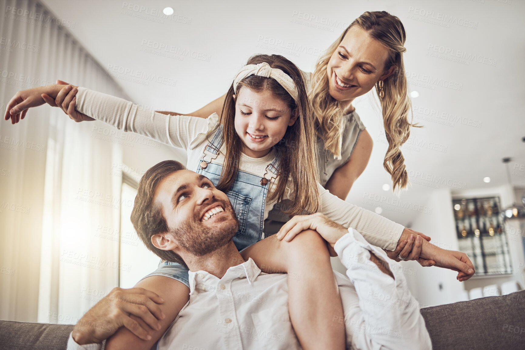 Buy stock photo Family, bonding and airplane game in living room, house or relax home in freedom activity, kids energy or fun playing. Smile, happy and flying child on father shoulders in fantasy support with mother