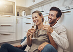 Laughing, love and couple with champagne in the kitchen for celebration, anniversary and valentines day. Comic, relax and funny man and woman drinking alcohol on the floor with happy conversation