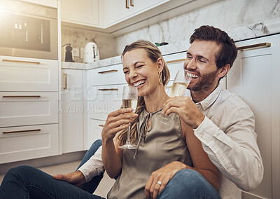 Buy stock photo Laughing, love and couple with champagne in the kitchen for celebration, anniversary and valentines day. Comic, relax and funny man and woman drinking alcohol on the floor with happy conversation