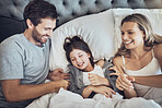 Family, happy and parents with child relax in bed, weekend or holiday break with love and bonding at home. Fun, happiness and love with care, man and woman with girl, joy and laugh together 