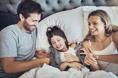 Buy stock photo Family, happy and parents with child relax in bed, weekend or holiday break with love and bonding at home. Fun, happiness and love with care, man and woman with girl, joy and laugh together 