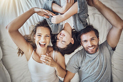 Buy stock photo Happy family relax together, parents and child in bed on the weekend, break with love, care and bonding at home. Portrait, happiness and joy, man, woman and girl laugh and peace with quality time